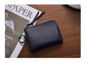 Mini dark blue zipper coin purse, compact minimalist leather pouch for women, daily portable wallet.