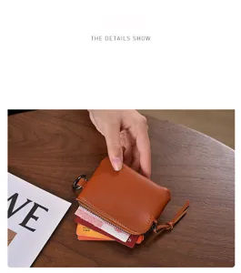 Compact brown leather mini coin purse and card holder with secure zipper and strap.