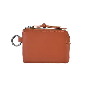 Compact brown leather coin purse with zipper closure and metal keychain ring for women.