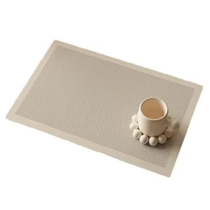 Close-up detail of modern waterproof leather placemat with striped texture and coaster.