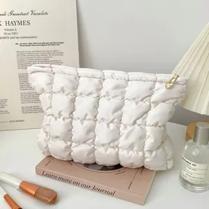White quilted puffer cosmetic bag, portable travel makeup pouch and toiletry organizer zipper bag.