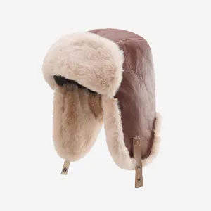 Brown faux leather trapper hat detail showing plush lining and snap button chin strap.