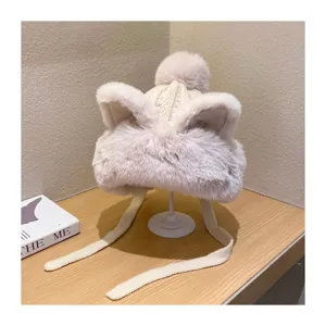 Detailed close-up of winter warm plush cat ear knitted hat with fluffy pom-pom and cozy ear flaps.