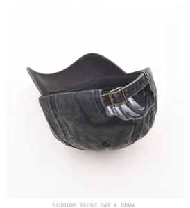 Vintage washed denim baseball cap with adjustable metal buckle strap, classic casual retro design.