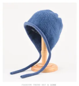 Detailed view of the blue plush knit bonnet hat with long ties, soft texture close-up.
