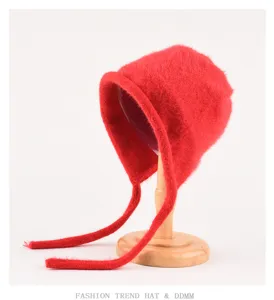 Winter red fluffy knit bonnet hat with ear flaps and long ties, cozy women's warm beanie.