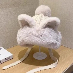 Winter warm plush ear-flap knitted hat with cute cat ears and fluffy pom-pom for women.