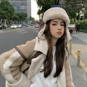 Winter faux leather trapper hat and shearling jacket set for warm outdoor cycling wear.