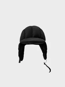Detailed close-up of a black padded winter trapper hat, warm windproof earflap bomber hat.