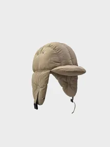 Close-up of quilted winter down trapper hat with warm earflaps and adjustable strap detail.