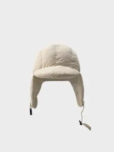 Quilted bomber hat with earflaps in beige, winter windproof warm ushanka cap for cold days.