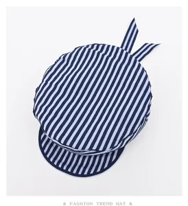 Detailed view of stylish blue and white striped sailor beret hat with cute ribbon.