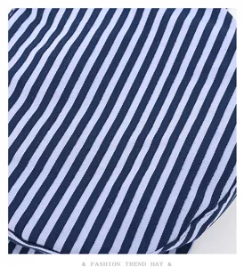 Detail view of the navy blue and white striped sailor flat cap fabric and pattern.