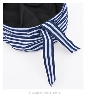Detailed close-up of blue and white striped sailor hat beret featuring stylish ties.