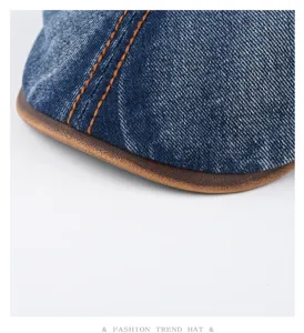 Vintage washed denim flat cap with brown leather brim and contrast stitching for adults.