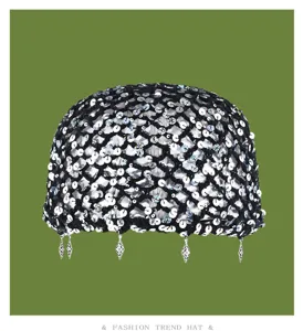 Close-up of black handmade crochet sequin mesh cap, vintage hollow design with small pendants.