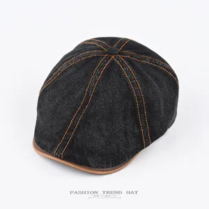 Classic denim flat cap with brown leather brim and contrast stitching, retro casual style.