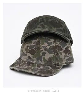 Close-up detail view of stacked vintage camouflage short brim caps with textured fabric.