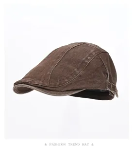 Brown washed denim flat cap detail, retro ivy newsboy hat side metal buckle view.