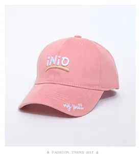 Close-up detail of the pink baseball cap featuring neat embroidery and curved brim.