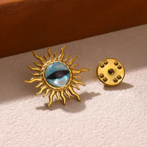Close-up detail of a stunning gold sunburst brooch featuring a mesmerizing blue evil eye center.