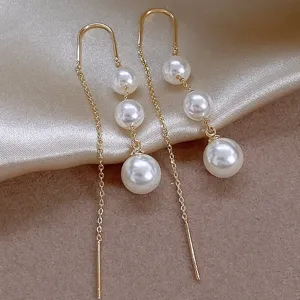 Gold long chain tassel earrings with faux pearls, elegant and luxurious daily jewelry design.