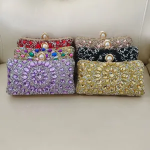 Detailed view of women's sparkling crystal evening clutch bags with pearl clasps and rhinestones.