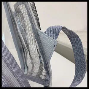 Transparent PVC backpack detail showcasing durable grey straps and mesh pocket construction.