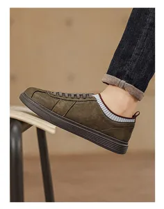 Close-up detail view of retro men casual sneaker, showcasing textured olive upper and collar.