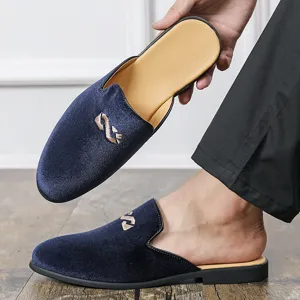 Men's navy blue velvet slip-on mules loafers showcasing upper design and worn look.