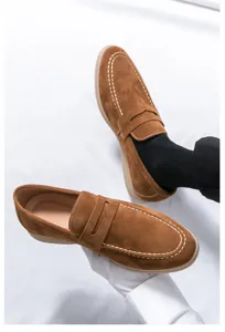 Men's stylish brown suede slip-on penny loafers casual driving shoes detail presentation.