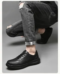 Primer plano de zapatos casuales de cuero negro para hombre en estudio fotográfico.