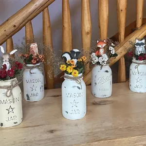 Detailed view of woodland animal wooden mason jar floral decor, rustic home table centerpieces.