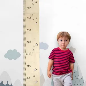 Wooden height growth chart for kids room with star cutouts and clear measurement scale.