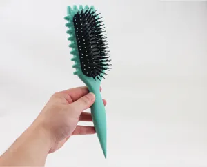 Mint green cushion hair brush with tail comb and black bristles for daily hair styling care.