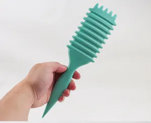Detail view of the green hair styling comb with unique ribbed teeth for bouncy curls.