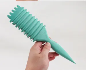 Close-up detail of the green wave curl styling hair brush with textured handle and bristles.