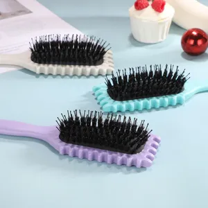Hair styling brush set with wavy handle and boars hair cushion bristles for curling hair.