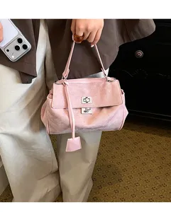 Detailed view of the pink suede shoulder handbag, showing premium texture and classic lock design.