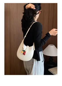 Detailed view of the elegant white hobo shoulder bag with strawberry charm and style.