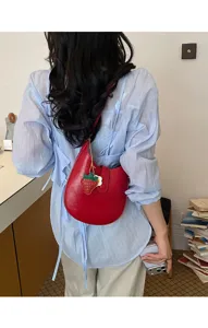 Minimalist red leather hobo shoulder bag for women, chic saddle purse with strawberry charm.
