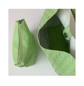 Light green woven leather handbag detail and matching pouch for daily chic casual use.