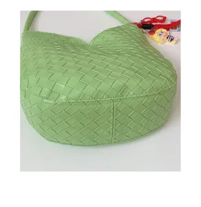 Green woven leather hobo underarm bag detail view showcasing intrecciato craftsmanship