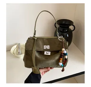 Detailed view of the olive green suede women handbag featuring double twist-lock closures.
