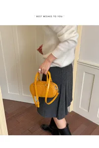 Detail shot of a yellow woven texture handbag, retro style, elegant handheld presentation.