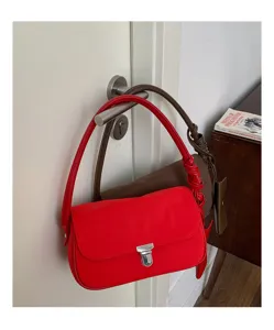 Minimalist nylon shoulder bag detail view, casual underarm handbag with unique knot strap.