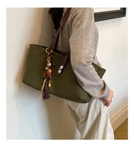 Retro large capacity canvas shoulder tote bag for women, casual versatile underarm bag with tassel.