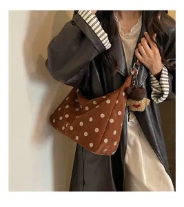 Brown corduroy hobo shoulder bag with white polka dots and cute knitted bear pendant.