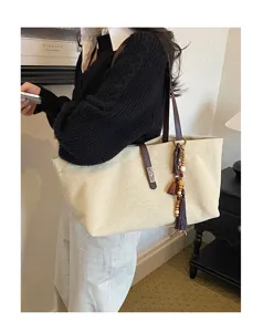 Retro large capacity canvas shoulder tote bag casual commuter handbag with tassel charm.