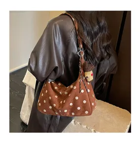 Vintage brown suede polka dot underarm shoulder bag detail showing stylish autumn design.